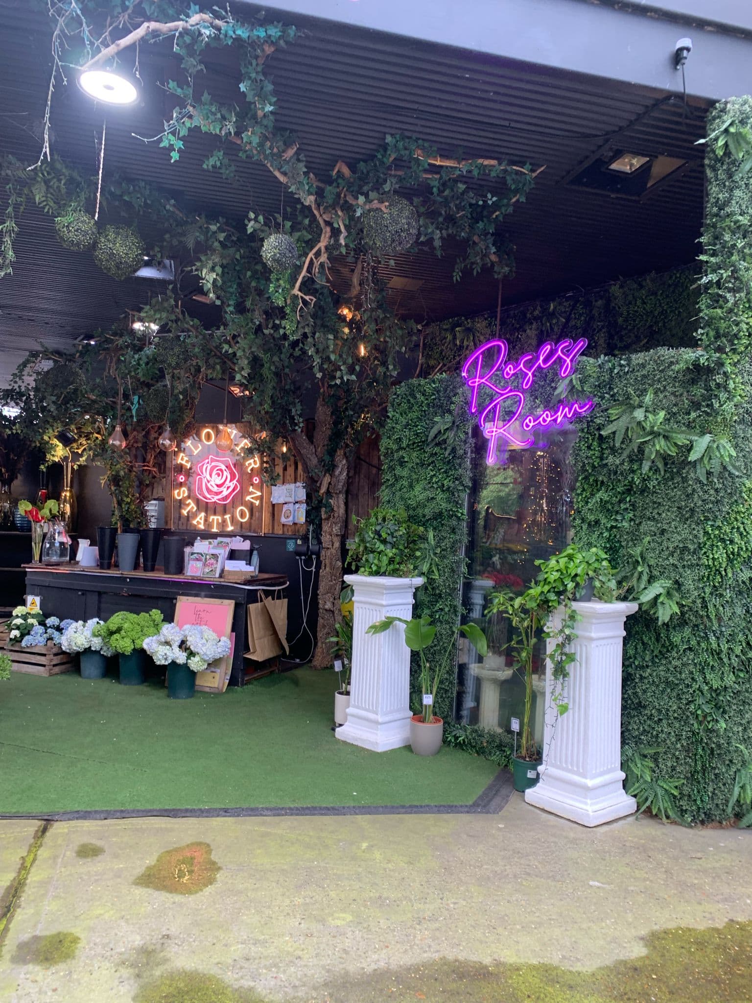 Flower Station entrance with neon Roses Room sign